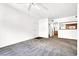 Spacious living room with plush carpet, ceiling fan, and a kitchen view at 6955 N Durango Dr # 1022, Las Vegas, NV 89149