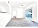 Living room offers neutral carpeting and sliding glass doors that let in plenty of natural light at 6955 N Durango Dr # 1022, Las Vegas, NV 89149