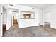 Bright living room featuring neutral carpeting, white walls and a pass through window to the kitchen at 6955 N Durango Dr # 1022, Las Vegas, NV 89149