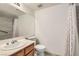 Bathroom features a vanity sink, toilet, and shower with patterned curtains at 697 Gull Point Ave, Las Vegas, NV 89123
