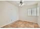 Minimalist bedroom with tile flooring, plantation shutters, and neutral wall color at 697 Gull Point Ave, Las Vegas, NV 89123