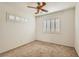 Cozy bedroom with neutral carpet, white walls, and plantation shutters on the windows at 697 Gull Point Ave, Las Vegas, NV 89123