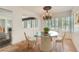 Dining room boasts a glass table, chandelier, and windows with plantation shutters at 697 Gull Point Ave, Las Vegas, NV 89123