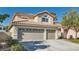 Charming two-story home featuring a three-car garage, tile roof, and well-maintained landscaping at 697 Gull Point Ave, Las Vegas, NV 89123
