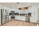 Modern kitchen features stainless steel appliances, granite countertops, and white cabinetry at 697 Gull Point Ave, Las Vegas, NV 89123