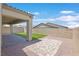 Spacious backyard with low maintenance gravel and artificial turf under a covered patio at 701 Webber Park St, Henderson, NV 89011