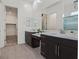 Bathroom featuring dual vanities with stone countertops and dark cabinets at 701 Webber Park St, Henderson, NV 89011