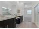 Bright primary bathroom featuring dual vanities, contemporary fixtures, and a glass-enclosed shower at 701 Webber Park St, Henderson, NV 89011
