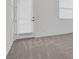 Bedroom with light gray carpet, white walls, and a sliding glass door to the outside at 701 Webber Park St, Henderson, NV 89011