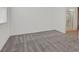 Bedroom featuring light gray carpet, white walls, and access to the en suite bathroom at 701 Webber Park St, Henderson, NV 89011