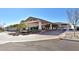 Elegant clubhouse entrance featuring covered parking, lush landscaping, and tasteful architecture at 701 Webber Park St, Henderson, NV 89011