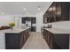 Modern kitchen features an island, stainless steel appliances, and dark cabinets at 701 Webber Park St, Henderson, NV 89011