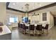 Elegant kitchen island with chairs, white cabinetry, stainless steel hood, and upscale finishes at 701 Webber Park St, Henderson, NV 89011