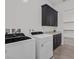 Efficient laundry room with modern appliances, dark cabinets, and a convenient folding counter at 701 Webber Park St, Henderson, NV 89011