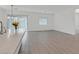 Open living space with kitchen and island, featuring modern pendant lighting and tile floors at 701 Webber Park St, Henderson, NV 89011