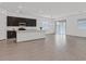 Inviting living space with a modern kitchen and an island with seating, all enhanced by neutral tones at 701 Webber Park St, Henderson, NV 89011