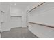 Spacious walk-in closet with carpeted floors and custom built-in shelves and rods at 701 Webber Park St, Henderson, NV 89011