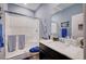 This bathroom features a shower with glass door, a vanity, and nautical decor, creating a fresh and clean look at 7109 Red Gulch St, North Las Vegas, NV 89084