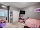 Simple bedroom with gray walls, a TV, and a sliding-door closet at 7109 Red Gulch St, North Las Vegas, NV 89084