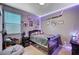 This bedroom features playful decor, a comfortable bed, and soft lighting, creating a cozy and inviting space at 7109 Red Gulch St, North Las Vegas, NV 89084