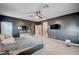 This bedroom has a ceiling fan, a wall mounted TV, and a door to the bathroom at 7109 Red Gulch St, North Las Vegas, NV 89084