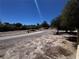 View of the common area, showcasing a paved pathway winding through a dry, desert landscape with scattered trees at 7273 Vista Bonita Dr, Las Vegas, NV 89149