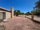 An enclosed gravel backyard with a stone chimney is visible on the side of the home, fenced for privacy at 7273 Vista Bonita Dr, Las Vegas, NV 89149