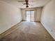 Spacious bedroom featuring neutral paint, carpet, and an exterior sliding glass door at 7273 Vista Bonita Dr, Las Vegas, NV 89149
