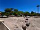 A large desert community common area with mature trees and natural boulder accents at 7273 Vista Bonita Dr, Las Vegas, NV 89149