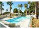 Community pool area featuring palm trees, lounge chairs, tables, and a large in-ground swimming pool on a sunny day at 7273 Vista Bonita Dr, Las Vegas, NV 89149