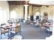 Restaurant interior with stone walls, wood beams, and elegantly set tables at 7273 Vista Bonita Dr, Las Vegas, NV 89149