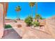 Palm trees in the backyard of the property, under a clear, blue sky at 7606 Kenwood Hills Ct, Las Vegas, NV 89131