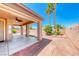 A covered patio with palm trees in the backyard of the property at 7606 Kenwood Hills Ct, Las Vegas, NV 89131