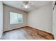 This bedroom features a window for natural light and wood flooring at 7606 Kenwood Hills Ct, Las Vegas, NV 89131