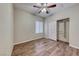 This bedroom features wood flooring, a closet and a ceiling fan at 7606 Kenwood Hills Ct, Las Vegas, NV 89131