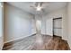 This bedroom features a ceiling fan, wood flooring, and a closet for storage at 7606 Kenwood Hills Ct, Las Vegas, NV 89131