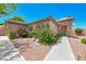 Single-story house with pink floral bushes, rock landscaping, and stone accents on the covered front porch at 7606 Kenwood Hills Ct, Las Vegas, NV 89131