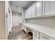 Hallway with built-in desk and storage cabinets, featuring wood floors at 7606 Kenwood Hills Ct, Las Vegas, NV 89131