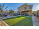 Beautiful backyard features artificial turf, brick pavers, and a cozy patio with hot tub at 7702 Wishbone Falls St, North Las Vegas, NV 89084