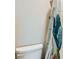 Charming half bathroom features a toilet and a shower with a blue curtain at 7702 Wishbone Falls St, North Las Vegas, NV 89084