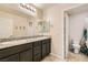 Well-lit bathroom features granite counters, dual sinks, and tile floors at 7702 Wishbone Falls St, North Las Vegas, NV 89084