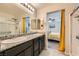 Bathroom featuring double sinks, with shower and bedroom entrance at 7702 Wishbone Falls St, North Las Vegas, NV 89084