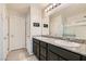 Bathroom featuring double sinks with granite countertop and a large mirror at 7702 Wishbone Falls St, North Las Vegas, NV 89084