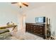 Spacious bedroom with dark dresser, television, and decorative accents at 7702 Wishbone Falls St, North Las Vegas, NV 89084