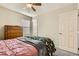 Comfortable bedroom with soft pink bedspread, decorative pillows, and natural light at 7702 Wishbone Falls St, North Las Vegas, NV 89084