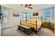 Bright bedroom featuring a ceiling fan, comfortable carpet, and natural light through the windows at 7702 Wishbone Falls St, North Las Vegas, NV 89084
