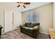 Relaxing bedroom featuring a comfortable sofa and abundant natural light at 7702 Wishbone Falls St, North Las Vegas, NV 89084