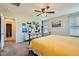 Bright bedroom featuring a ceiling fan, soft carpet, and natural light through the windows at 7702 Wishbone Falls St, North Las Vegas, NV 89084