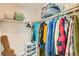 Walk-in closet with extensive shelving and a variety of clothing items at 7702 Wishbone Falls St, North Las Vegas, NV 89084