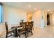Dining room with wood table, four chairs, and adjacent access to other rooms at 7702 Wishbone Falls St, North Las Vegas, NV 89084